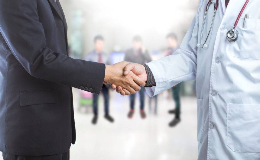 Businessman and doctor shaking hand's for some agreement